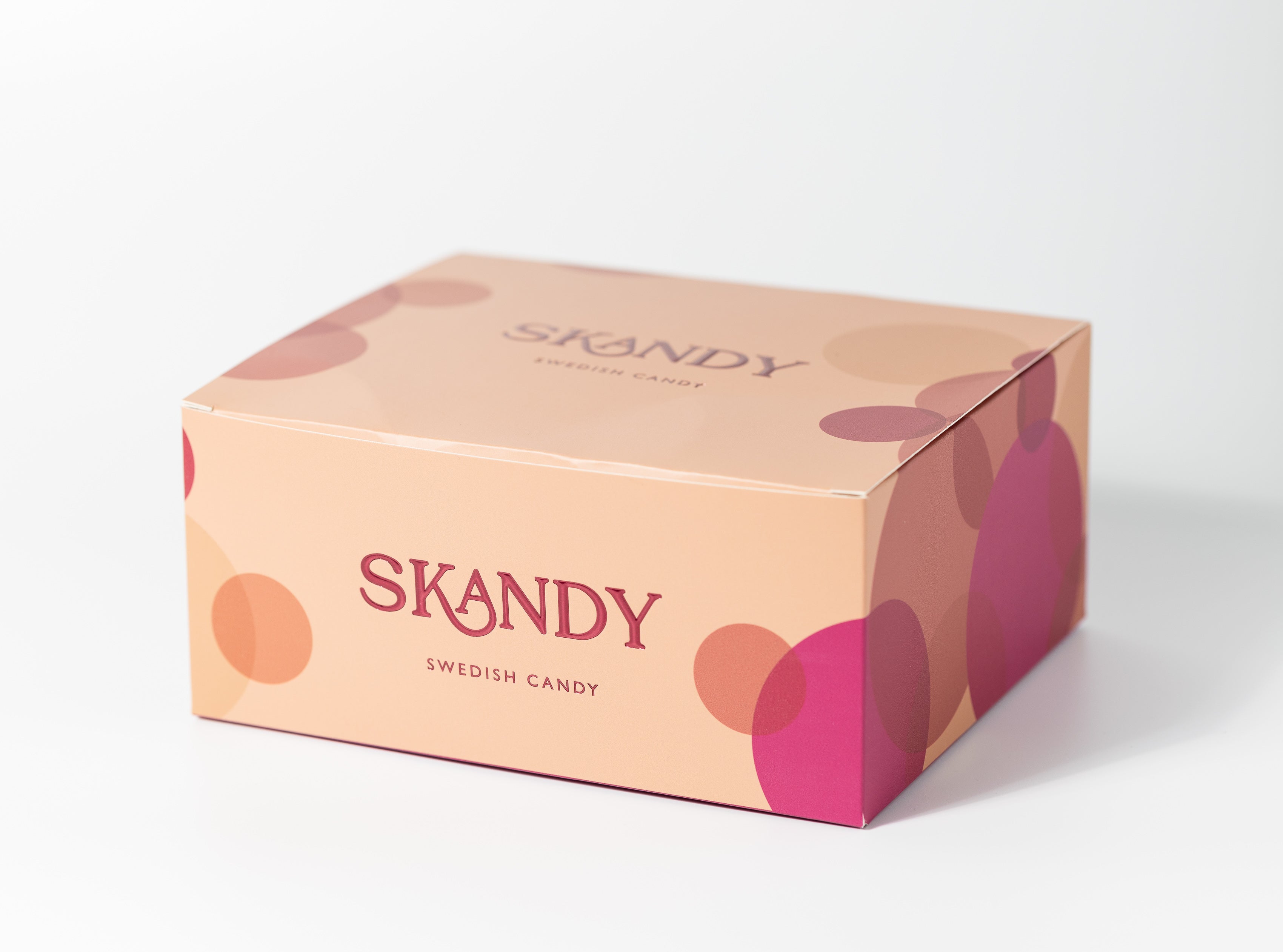 a light pink candy gift box with printed bubbles in pink tones resembling candy selection from Sweden